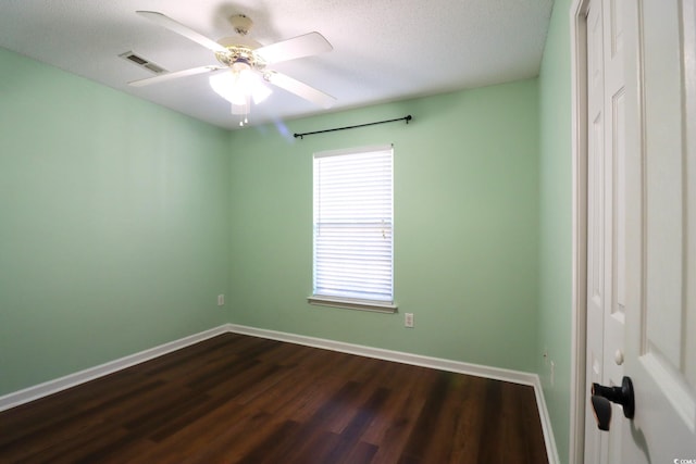 unfurnished room featuring ceiling fan, dark hardwood / wood-style floors, and a textured ceiling