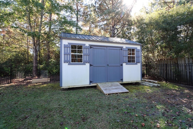 view of outbuilding featuring a yard