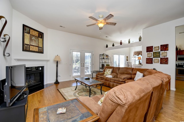 living room featuring french doors, hardwood / wood-style flooring, and ceiling fan