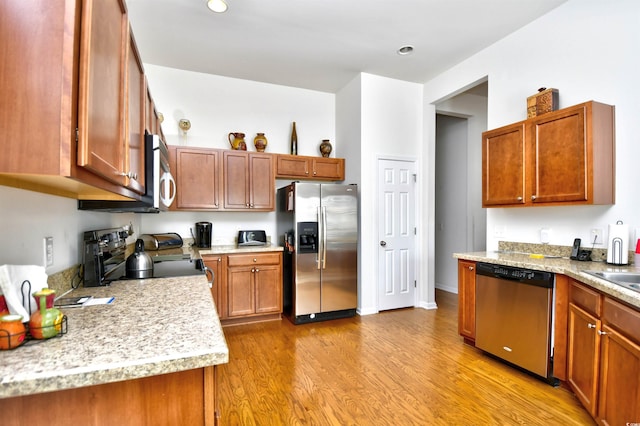 kitchen featuring stainless steel appliances and light hardwood / wood-style floors