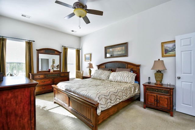 bedroom with ceiling fan and light carpet