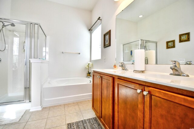 bathroom featuring vanity, tile patterned flooring, and separate shower and tub