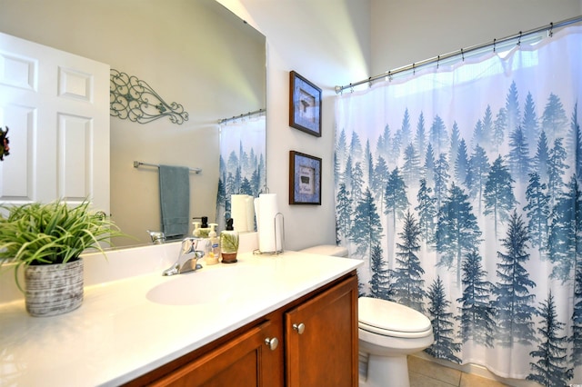 bathroom with vanity, tile patterned floors, and toilet