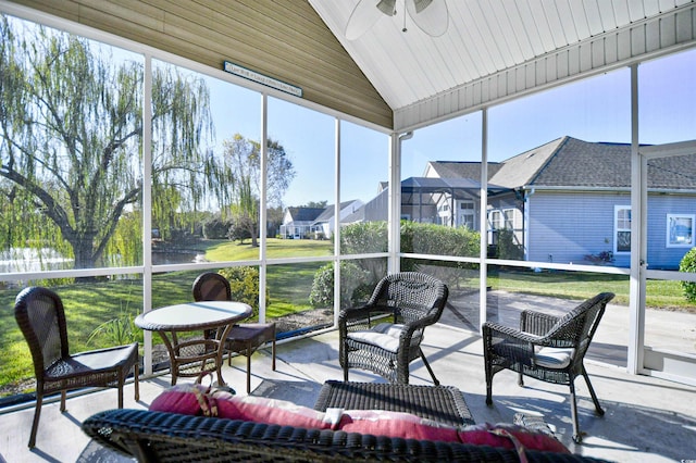 sunroom / solarium featuring a wealth of natural light, lofted ceiling, and ceiling fan