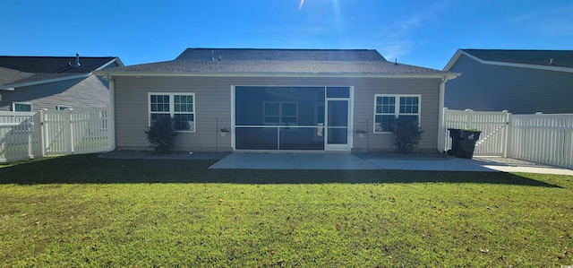 back of property with a patio, a sunroom, and a yard