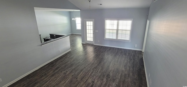 unfurnished room with dark wood-type flooring and lofted ceiling