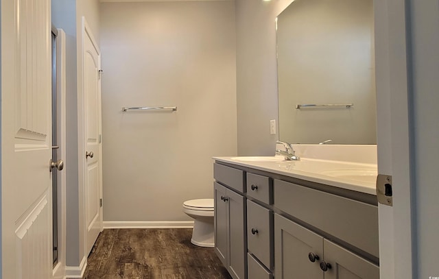 bathroom featuring hardwood / wood-style flooring, vanity, and toilet