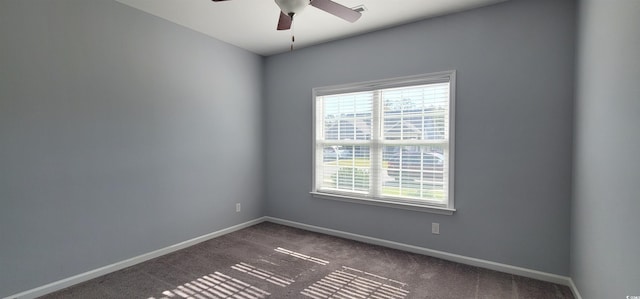 carpeted spare room with ceiling fan