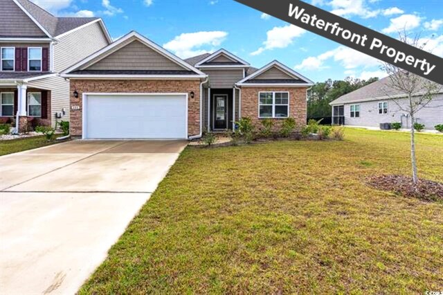 craftsman-style home with a front lawn and a garage