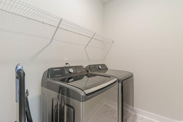 laundry area with washing machine and clothes dryer