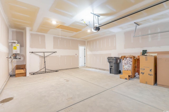 garage featuring a garage door opener and water heater