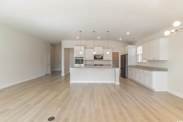 kitchen with white cabinetry, appliances with stainless steel finishes, a kitchen island with sink, and decorative light fixtures