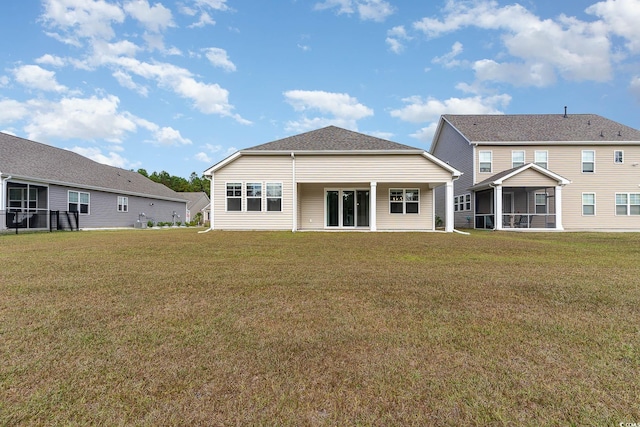 rear view of house with a lawn