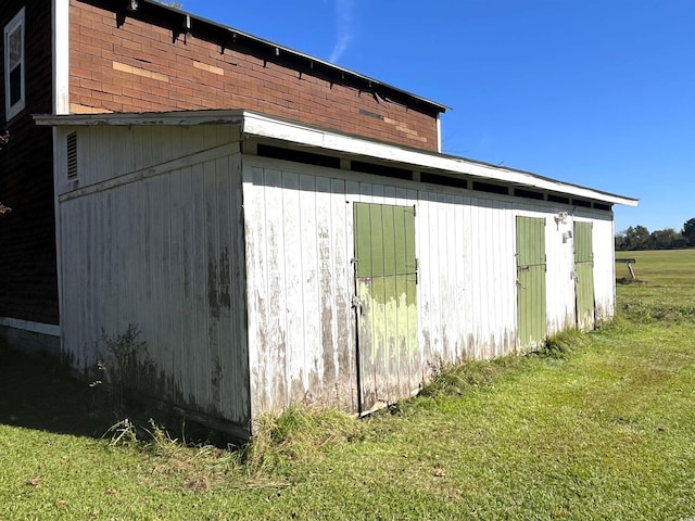 view of outbuilding with a lawn