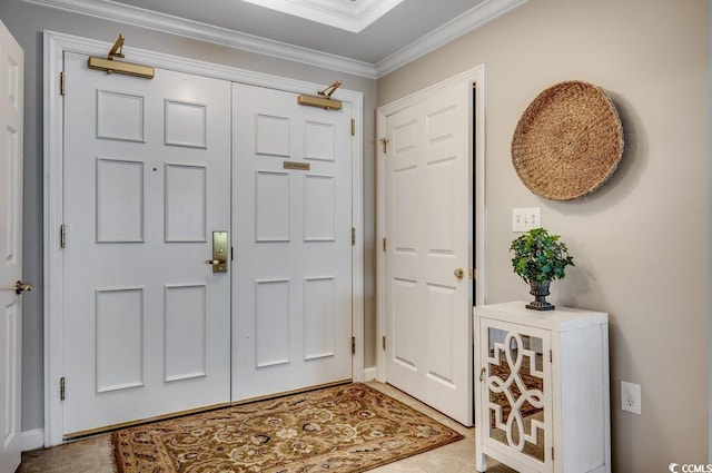 foyer entrance featuring tile patterned floors and crown molding