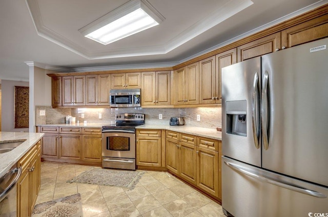 8500 Margate Cir Unit 2704, Myrtle Beach, SC 29572 - kitchen featuring appliances with stainless steel finishes, backsplash, ornamental molding, light stone countertops, and a tray ceiling