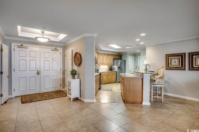 8500 Margate Cir Unit 2704, Myrtle Beach, SC 29572 - kitchen with appliances with stainless steel finishes, a peninsula, a breakfast bar area, ornamental molding, and light tile patterned flooring