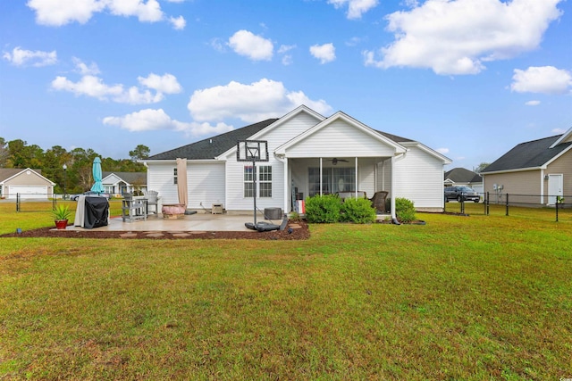 back of house with a yard, a patio, and ceiling fan