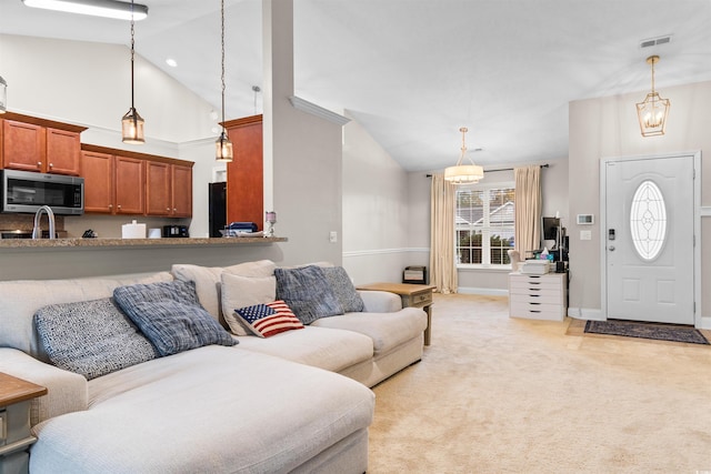 living room with light carpet and high vaulted ceiling