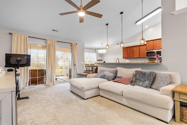 living room with ceiling fan, high vaulted ceiling, and light colored carpet