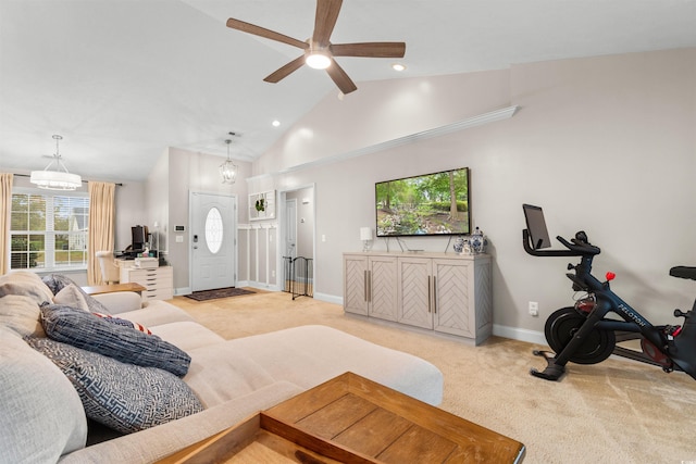 living room featuring light carpet, high vaulted ceiling, and ceiling fan with notable chandelier