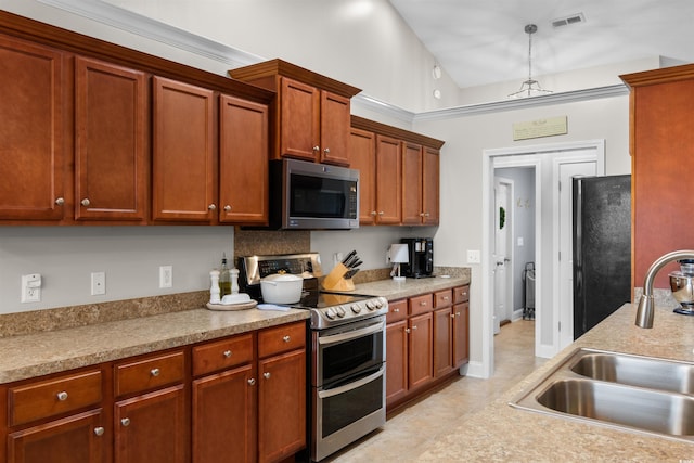 kitchen featuring appliances with stainless steel finishes, sink, light tile patterned floors, high vaulted ceiling, and hanging light fixtures