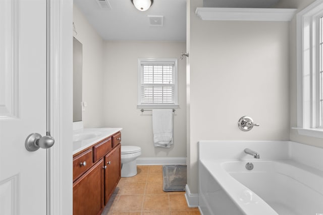 bathroom featuring tile patterned floors, vanity, crown molding, toilet, and a tub