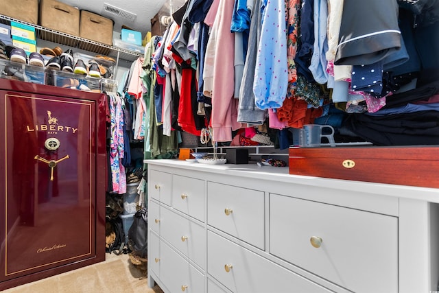 spacious closet featuring light carpet