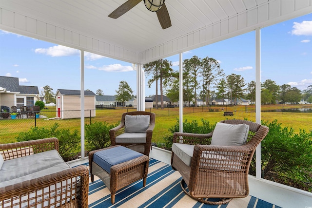 sunroom / solarium featuring ceiling fan