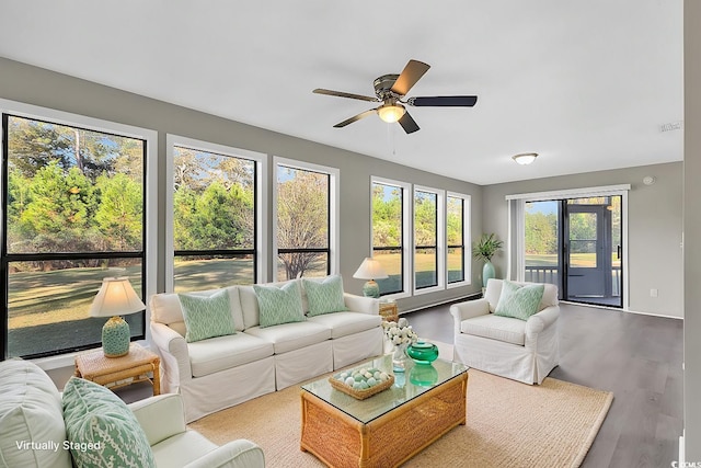 sunroom / solarium featuring ceiling fan