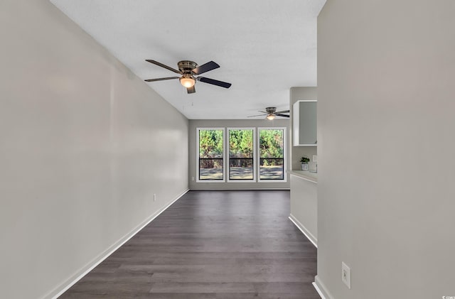 hall with dark hardwood / wood-style floors and vaulted ceiling