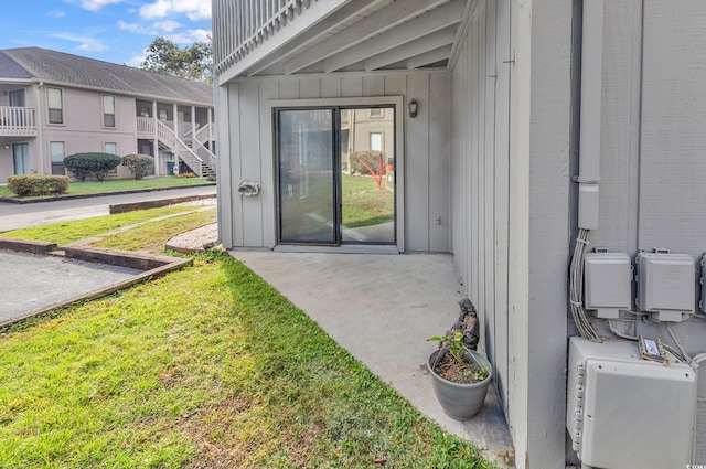 doorway to property featuring a yard