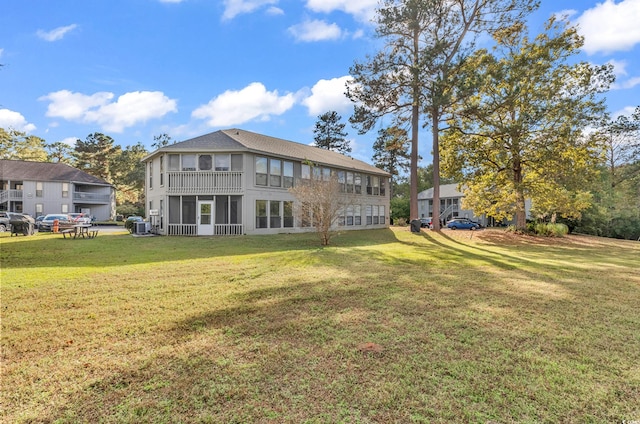 back of property with a lawn and central air condition unit