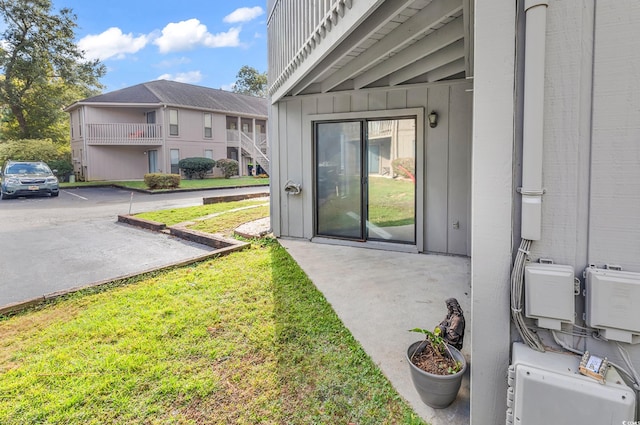 entrance to property featuring a lawn