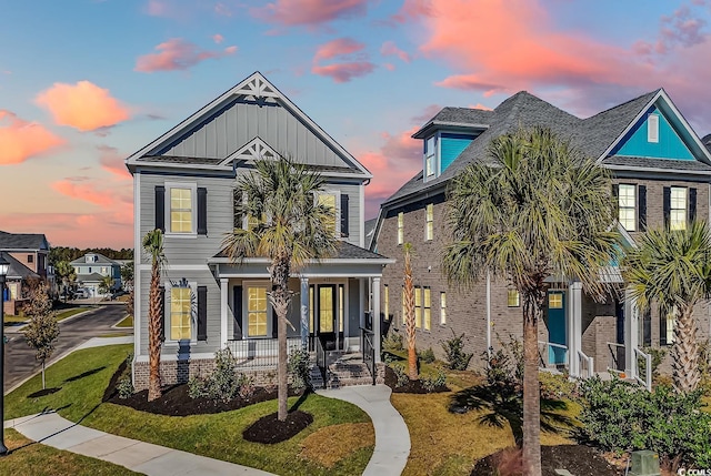 view of front of home featuring a lawn and a porch