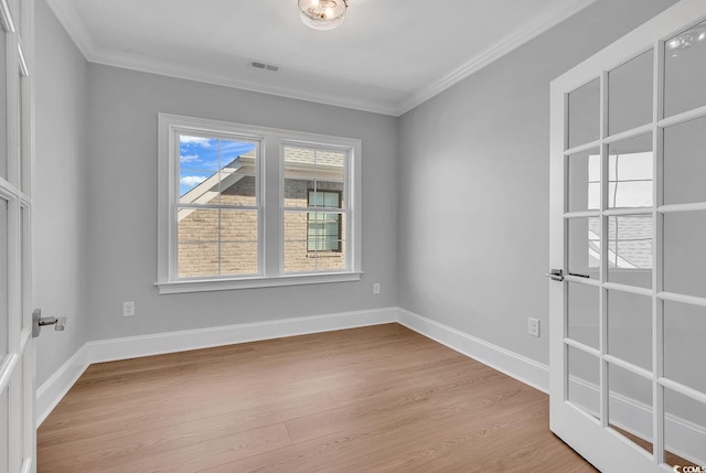 unfurnished room featuring light hardwood / wood-style floors and crown molding