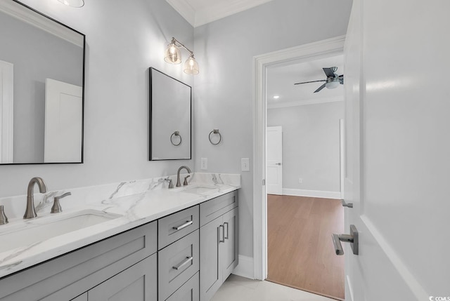 bathroom featuring hardwood / wood-style floors, ceiling fan, ornamental molding, and vanity