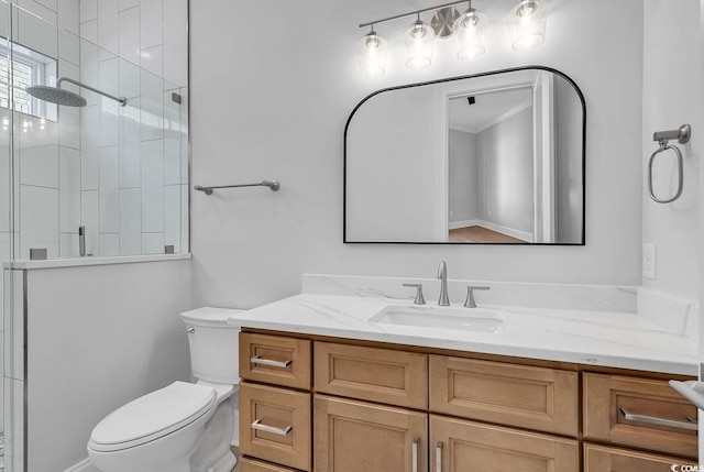 bathroom featuring vanity, toilet, and an enclosed shower