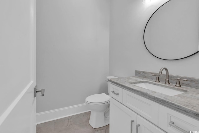 bathroom with tile patterned flooring, vanity, and toilet