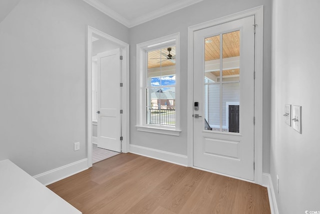 entrance foyer with light hardwood / wood-style floors and crown molding