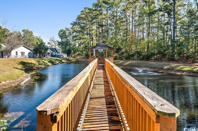 view of dock with a gazebo and a water view