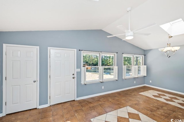 interior space featuring vaulted ceiling with skylight and ceiling fan with notable chandelier