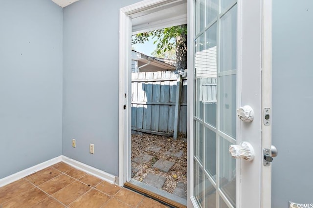 doorway to outside with tile patterned flooring