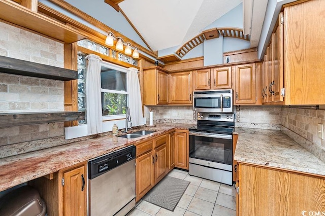 kitchen with decorative backsplash, appliances with stainless steel finishes, vaulted ceiling, sink, and light tile patterned floors