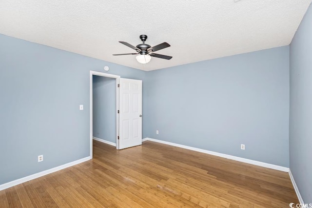 empty room with wood-type flooring, a textured ceiling, and ceiling fan