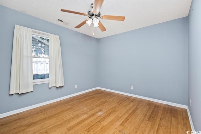 unfurnished room with ceiling fan and wood-type flooring