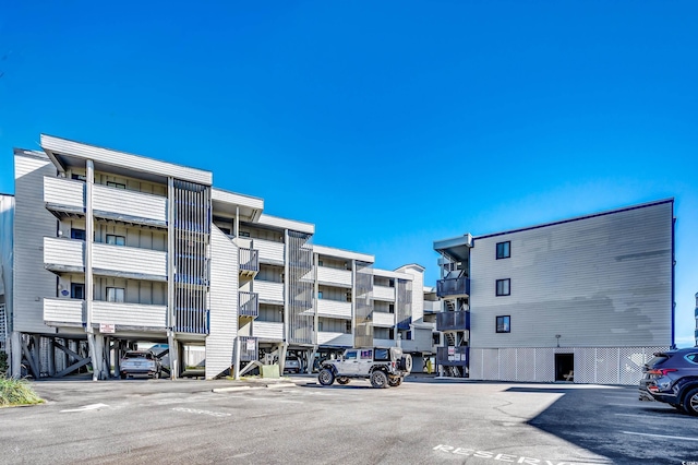 814 N Waccamaw Dr Unit 311, Garden City Beach, SC 29576 - view of apartment building / complex featuring uncovered parking