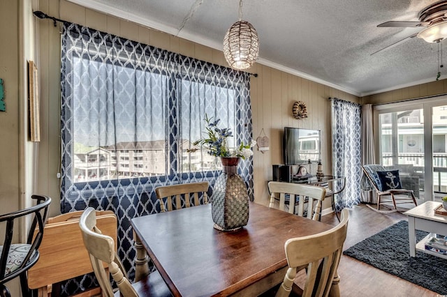 814 N Waccamaw Dr Unit 311, Garden City Beach, SC 29576 - dining room featuring ornamental molding, ceiling fan, a textured ceiling, healthy amount of natural light, and wood finished floors