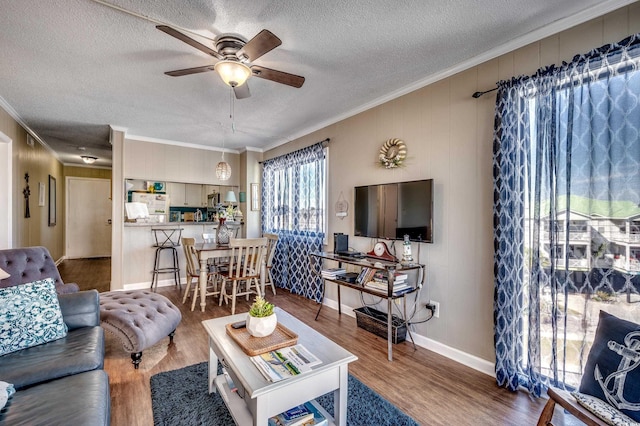 814 N Waccamaw Dr Unit 311, Garden City Beach, SC 29576 - living area with a ceiling fan, ornamental molding, wood finished floors, and a textured ceiling