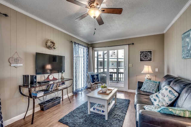 814 N Waccamaw Dr Unit 311, Garden City Beach, SC 29576 - living room featuring ornamental molding, a ceiling fan, wood finished floors, a textured ceiling, and wood walls